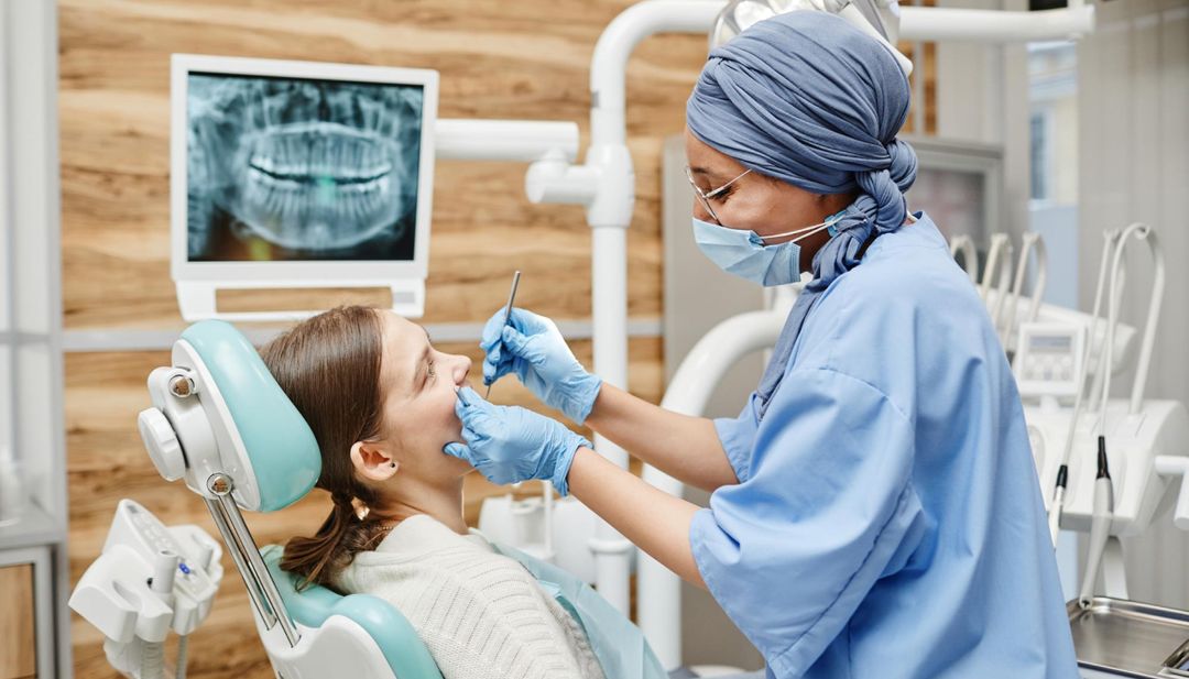 An orthodontist examining a young patient