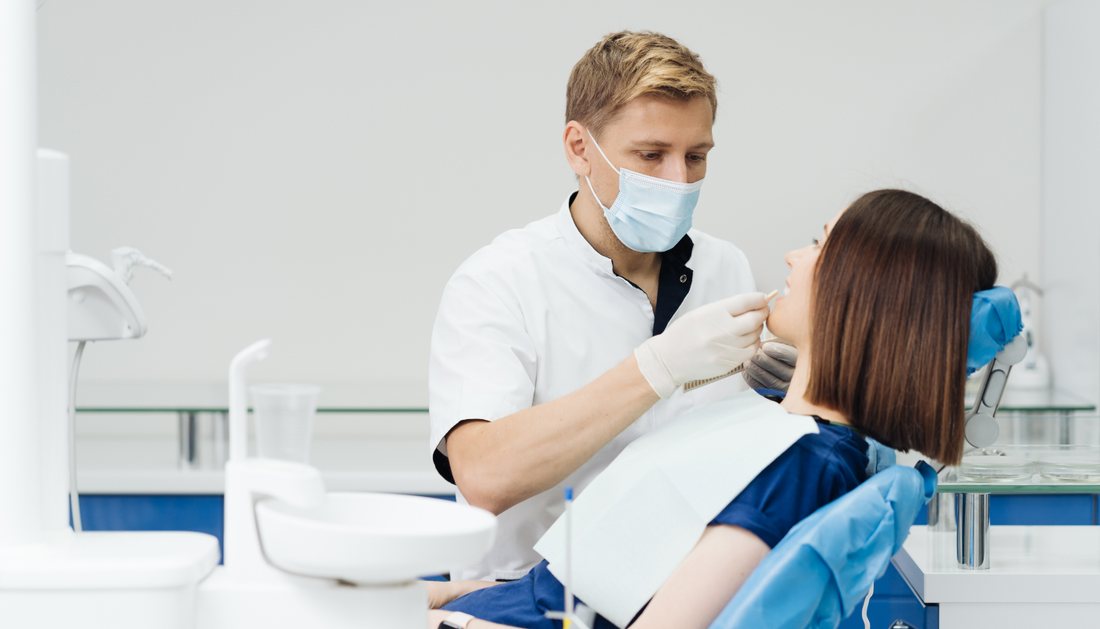An orthodontist examining a patient