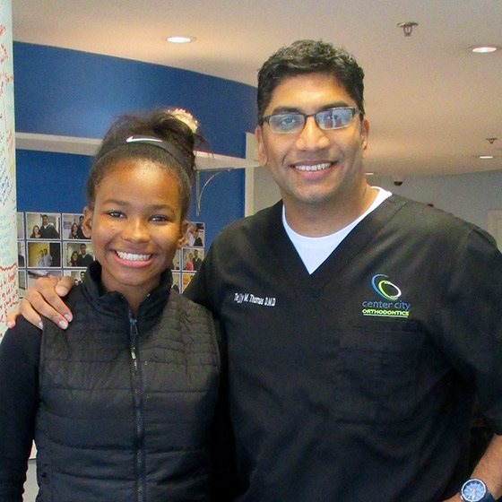 Dr. Thomas with a smiling teenage girl