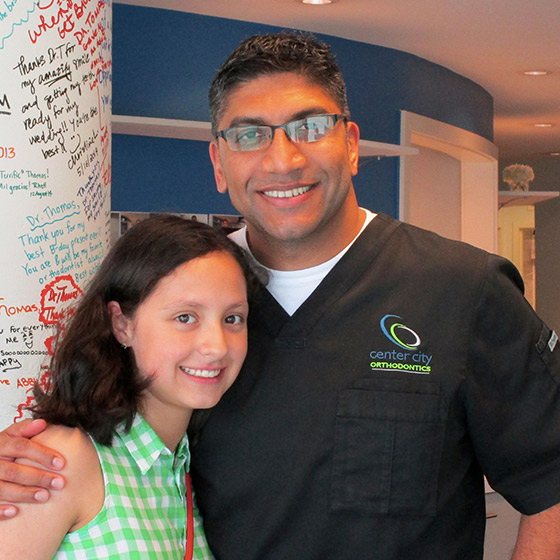 Dr. Thomas with a smiling girl