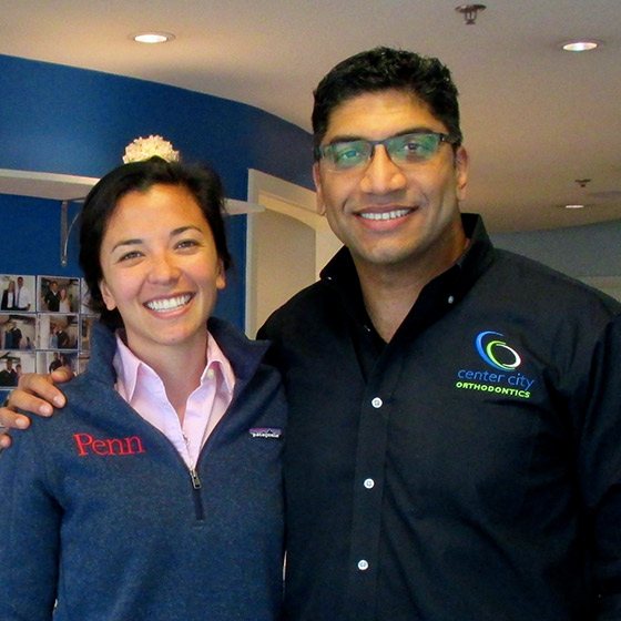 Dr. Thomas with a smiling woman in a Penn sweater