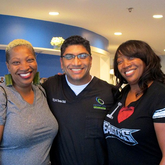Dr. Thomas with two smiling women