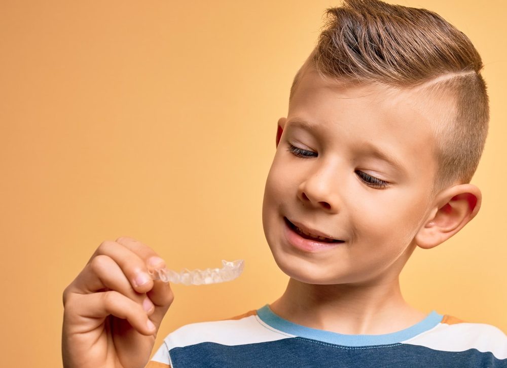 Boy looking at a clear aligner