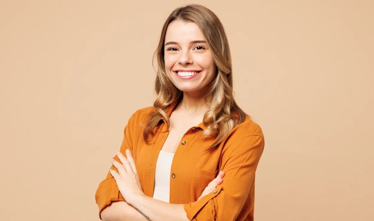 A smiling woman with her arms crossed