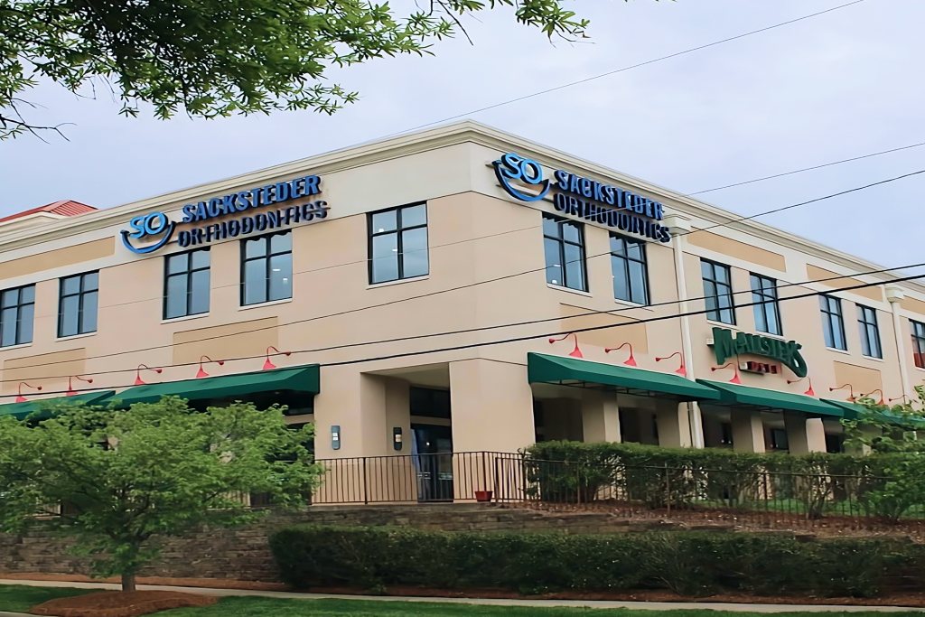 The Sacksteder Orthodontics building, with the practice sign above the green awnings