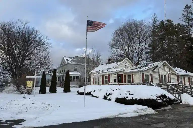 The Smileworks office, a white house with red shutters, in the snow