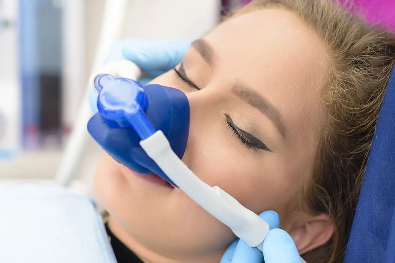 A relaxed patient breathing through a nitrous oxide nose mask